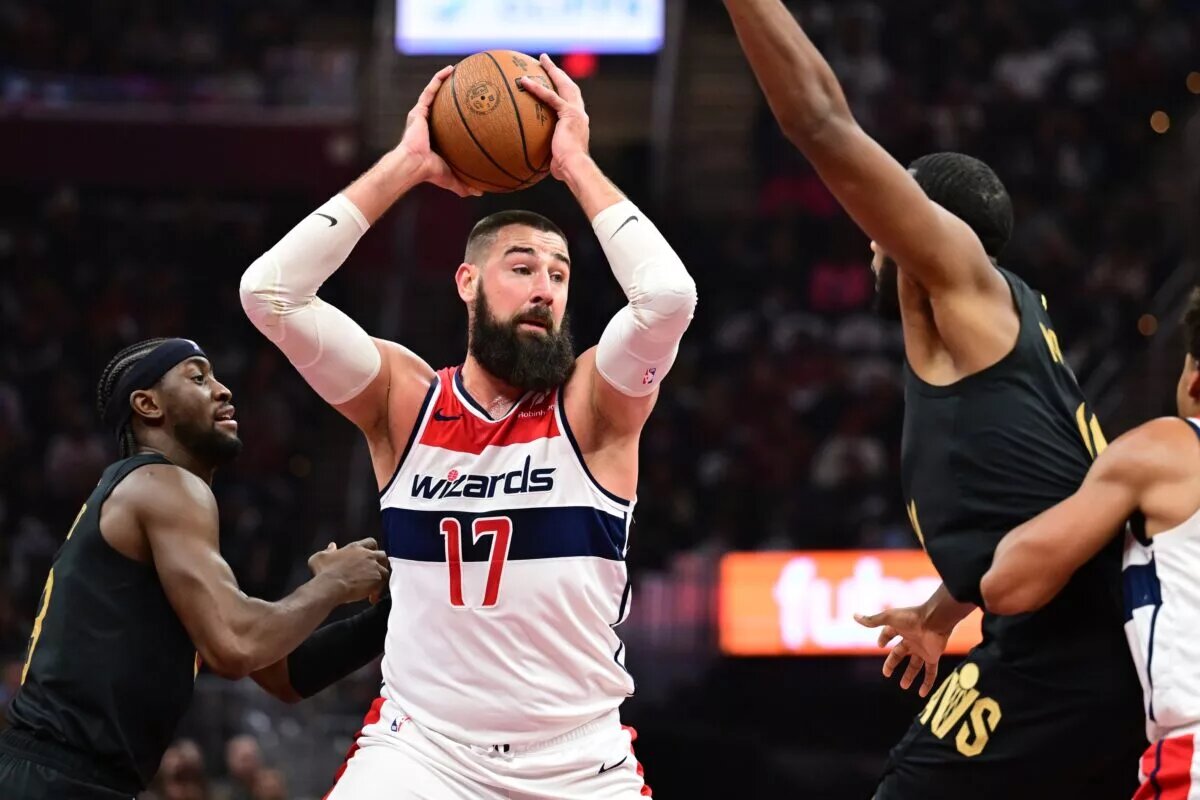 Dec 3, 2024; Cleveland, Ohio, USA; Washington Wizards center Jonas Valanciunas (17) controls the ball against Cleveland Cavaliers forward Evan Mobley (4) during the first half at Rocket Mortgage FieldHouse. Mandatory Credit: Ken Blaze-Imagn Images