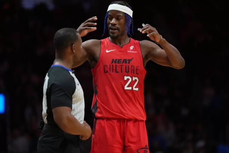 Dec 7, 2024; Miami, Florida, USA; Miami Heat forward Jimmy Butler (22) talks with official Dedric Taylor during a timeout in the second half against the Phoenix Suns at Kaseya Center. Mandatory Credit: Jim Rassol-Imagn Images