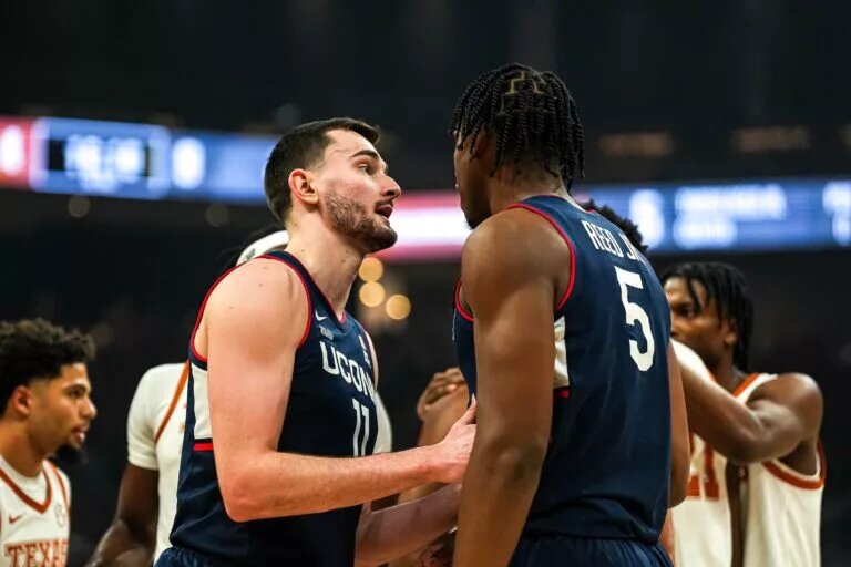 University of Connecticut forward Alex Karaban (11) talks to center Tarris Reed Jr. (5) during the game against the Texas Longhorns at the Moody Center on Sunday, Dec. 8, 2024.