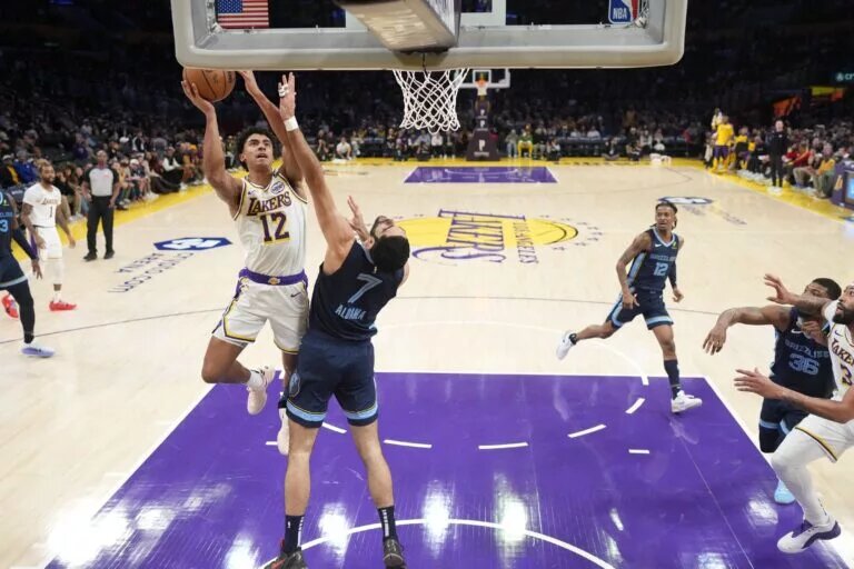 Dec 15, 2024; Los Angeles, California, USA; Los Angeles Lakers guard Max Christie (12) shoots the ball against Memphis Grizzlies forward Santi Aldama (7) in the first half at Crypto.com Arena. Mandatory Credit: Kirby Lee-Imagn Images