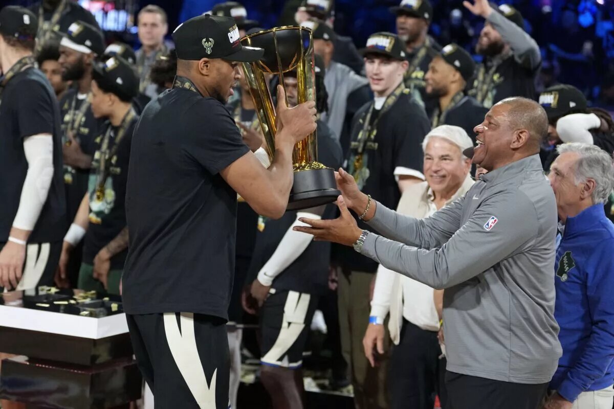Dec 17, 2024; Las Vegas, Nevada, USA; Milwaukee Bucks forward Giannis Antetokounmpo (34) hands the trophy to head coach Doc Rivers after winning the Emirates NBA Cup championship game against the Oklahoma City Thunder at T-Mobile Arena. Mandatory Credit: Kyle Terada-Imagn Images