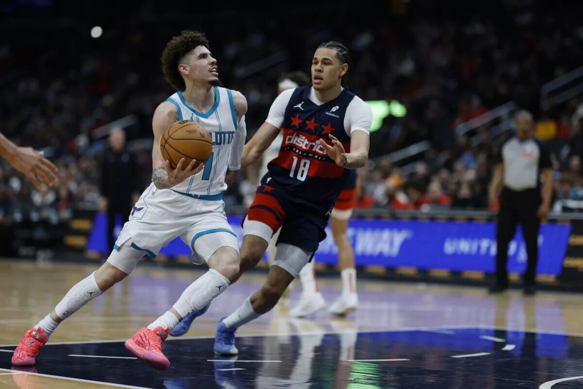 Dec 26, 2024; Washington, District of Columbia, USA; Charlotte Hornets guard LaMelo Ball (1) drives to the basket as Washington Wizards forward Kyshawn George (18) defends in the second quarter at Capital One Arena.