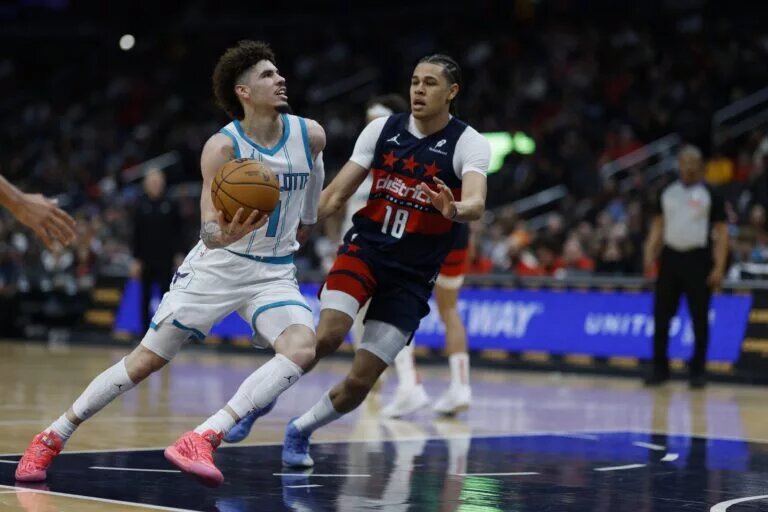 Dec 26, 2024; Washington, District of Columbia, USA; Charlotte Hornets guard LaMelo Ball (1) drives to the basket as Washington Wizards forward Kyshawn George (18) defends in the second quarter at Capital One Arena.