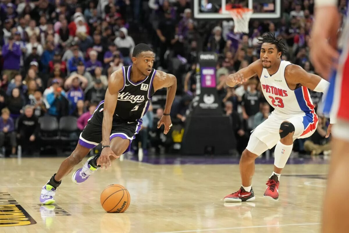Dec 26, 2024; Sacramento, California, USA; Sacramento Kings guard De'Aaron Fox (5) drives in against Detroit Pistons guard Jaden Ivey (23) during the fourth quarter at Golden 1 Center.