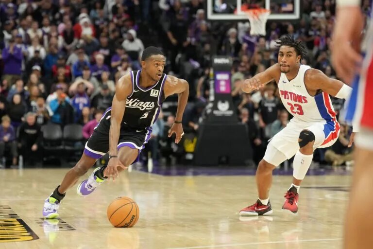Dec 26, 2024; Sacramento, California, USA; Sacramento Kings guard De'Aaron Fox (5) drives in against Detroit Pistons guard Jaden Ivey (23) during the fourth quarter at Golden 1 Center.