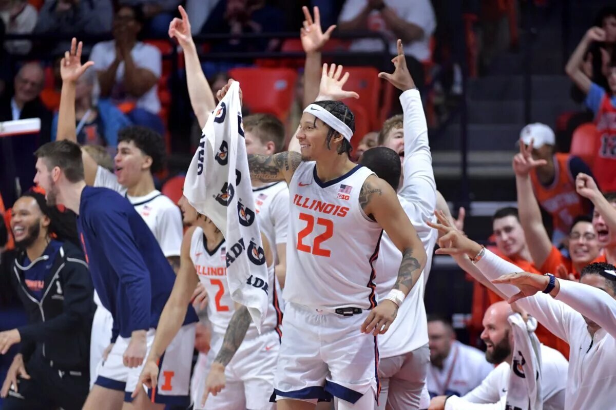 Illinois Fighting Illini players celebrate teammate Kylan Boswell (4) after he recorded a triple double in a 117-64 win over the Chicago State Cougars at State Farm Center.