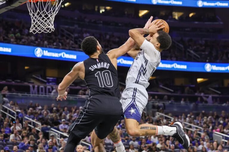 Dec 29, 2024; Orlando, Florida, USA; Orlando Magic guard Cole Anthony (50) is fouled by Brooklyn Nets guard Ben Simmons (10) during the second half at Kia Center.