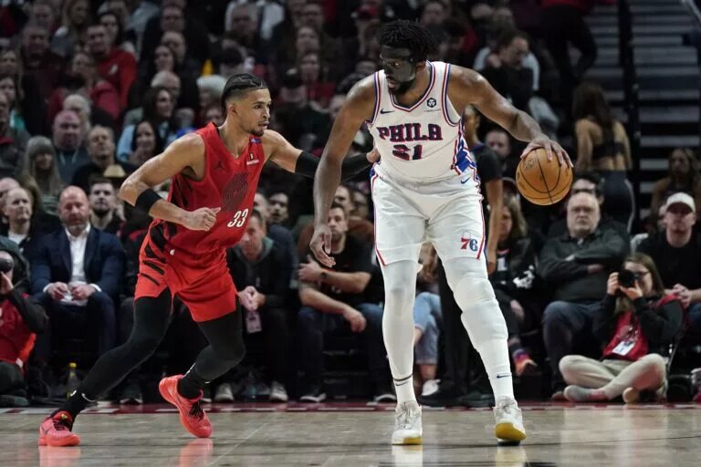 Dec 30, 2024; Portland, Oregon, USA; Philadelphia 76ers center Joel Embiid (21) handles the ball against Portland Trail Blazers forward Toumani Camara (33) during the second half at Moda Center.