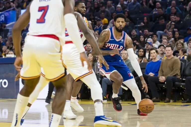 Philadelphia 76ers forward Paul George (8) dribbles against the Golden State Warriors