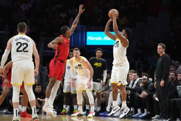 Utah Jazz forward Brice Sensabaugh (28) shoots over Miami Heat guard Josh Christopher (8)