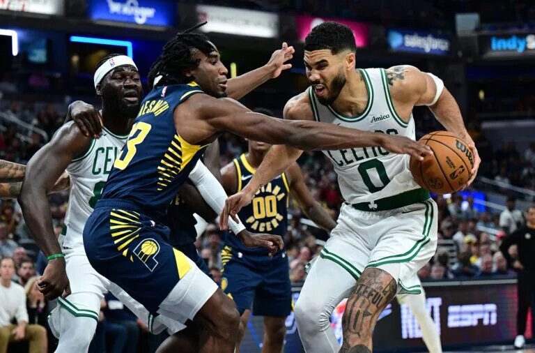 Indiana Pacers forward Aaron Nesmith (23) gets a hand on a ball controlled by Boston Celtics forward Jayson Tatum (0)