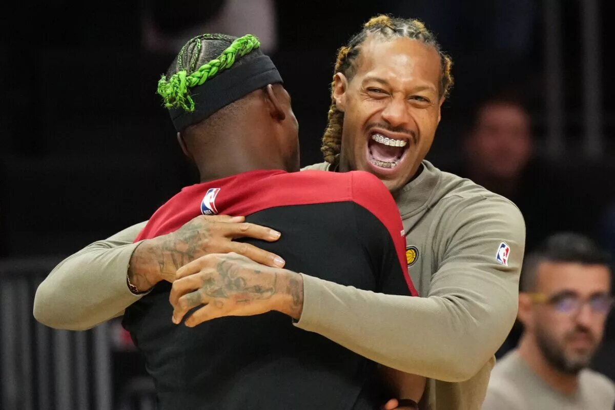 Indiana Pacers forward James Johnson (right) hugs Miami Heat forward Jimmy Butler during warm-ups