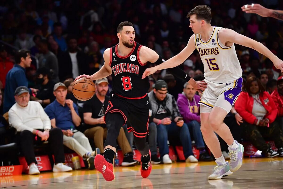 Chicago Bulls guard Zach LaVine dribbles down the court while defended by Los Angeles Lakers guard Austin Reaves