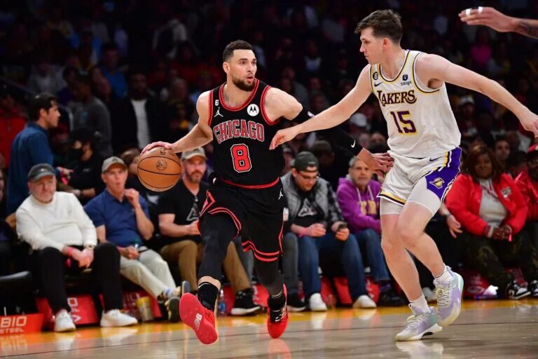 Chicago Bulls guard Zach LaVine dribbles down the court while defended by Los Angeles Lakers guard Austin Reaves