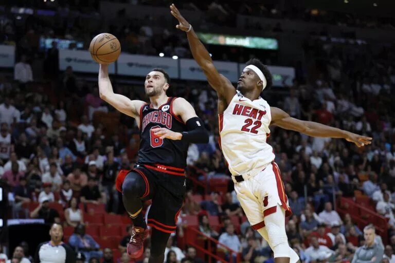 Chicago Bulls guard Zach LaVine dunks while guarded by Miami Heat forward Jimmy Butler