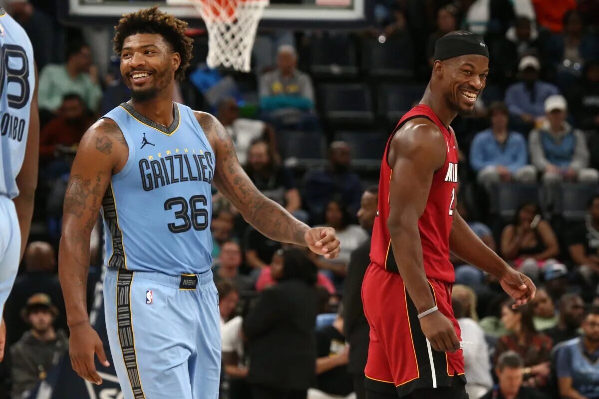 Miami Heat forward Jimmy Butler and Memphis Grizzlies guard Marcus Smart share a laugh