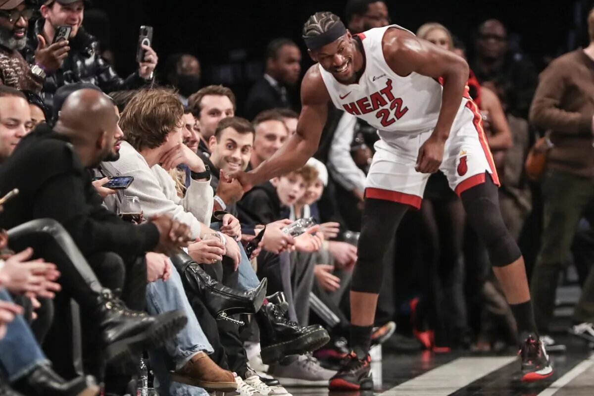 Miami Heat forward Jimmy Butler laughs with Brooklyn Nets fans