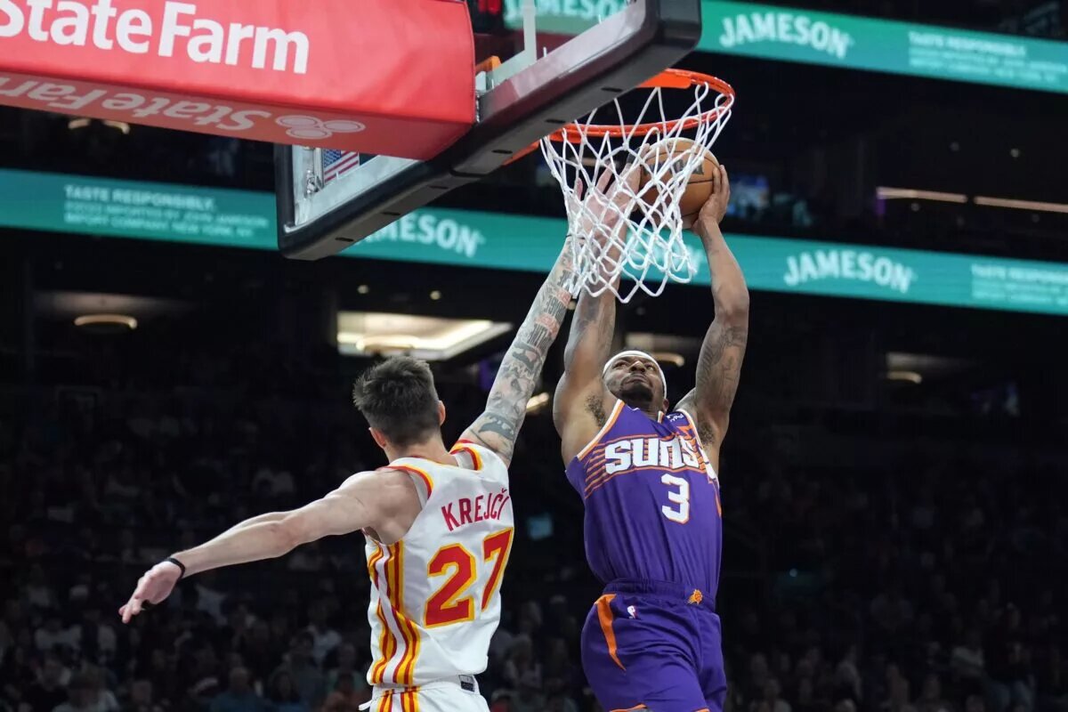 Phoenix Suns guard Bradley Beal dunks over Atlanta Hawks guard Vit Krejci