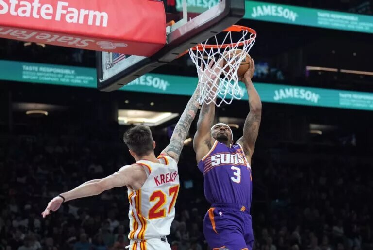 Phoenix Suns guard Bradley Beal dunks over Atlanta Hawks guard Vit Krejci