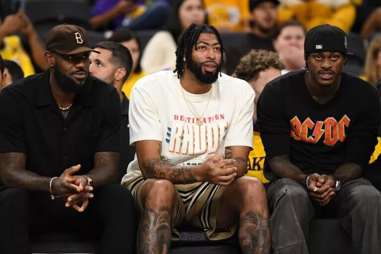 Oct 4, 2024; Palm Desert, California, USA; Los Angeles Lakers forward Anthony Davis (3), forward LeBron James (23) and forward Jarred Vanderbilt (2) on the sidelines against the Minnesota Timberwolves during the second half at Acrisure Arena. Mandatory Credit: Jonathan Hui-Imagn Images