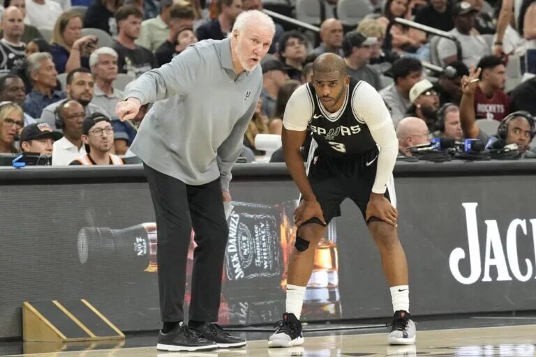 San Antonio Spurs head coach Gregg Popovich instructs Chris Paul on the sideline