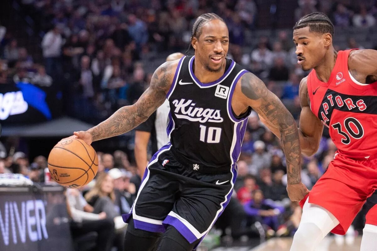 Nov 6, 2024; Sacramento, California, USA; Sacramento Kings forward DeMar DeRozan (10) drives to the basket against Toronto Raptors guard Ochai Agbaji (30) during the first quarter at Golden 1 Center.