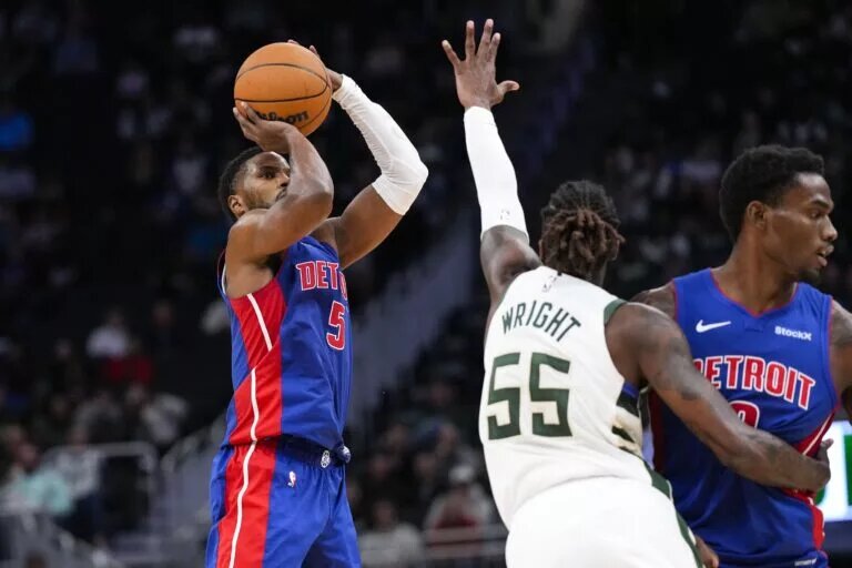 Nov 13, 2024; Milwaukee, Wisconsin, USA; Detroit Pistons guard Malik Beasley (5) shoots against Milwaukee Bucks guard Delon Wright (55) during the third quarter at Fiserv Forum.