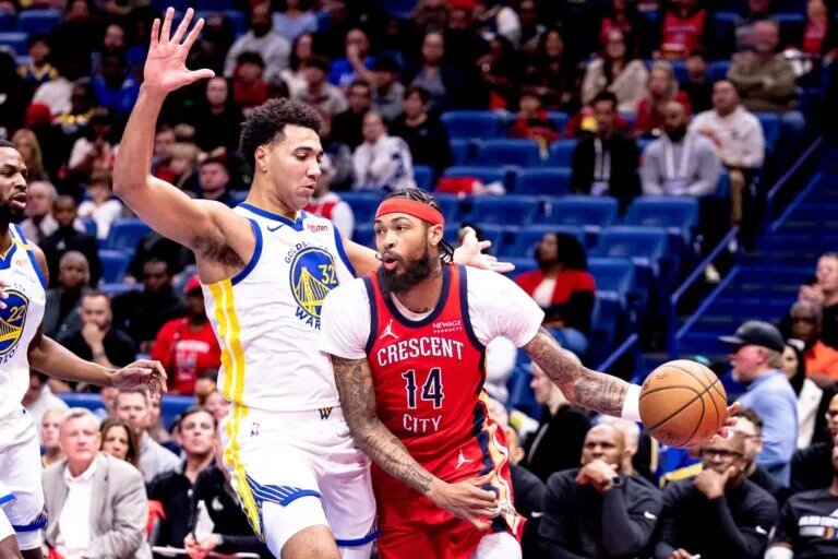 Nov 22, 2024; New Orleans, Louisiana, USA; New Orleans Pelicans forward Brandon Ingram (14) dribbles against Golden State Warriors forward Trayce Jackson-Davis (32) during first half at Smoothie King Center. Mandatory Credit: Stephen Lew-Imagn Images