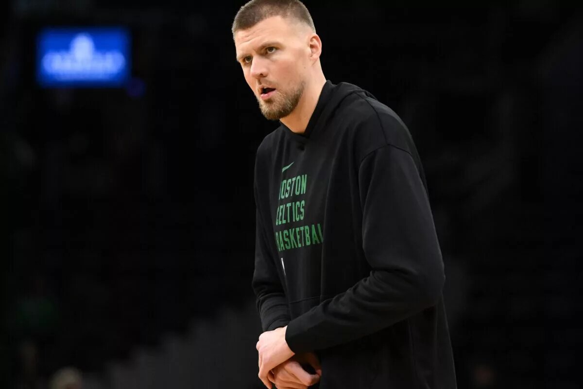 Dec 4, 2024; Boston, Massachusetts, USA; Boston Celtics center Kristaps Porzingis (8) holds his wrist during warmups before a game against the Detroit Pistons at the TD Garden. Mandatory Credit: Brian Fluharty-Imagn Images
