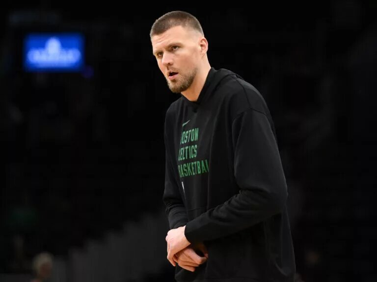 Dec 4, 2024; Boston, Massachusetts, USA; Boston Celtics center Kristaps Porzingis (8) holds his wrist during warmups before a game against the Detroit Pistons at the TD Garden. Mandatory Credit: Brian Fluharty-Imagn Images