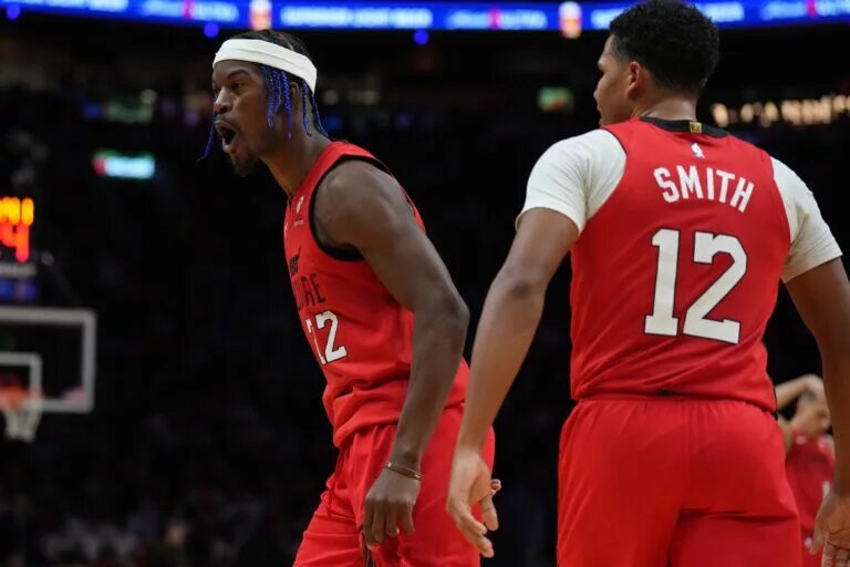 Dec 7, 2024; Miami, Florida, USA; Miami Heat forward Jimmy Butler (22) celebrates with guard Dru Smith (12) after a three-point-play against the Phoenix Suns during the second half at Kaseya Center. Mandatory Credit: Jim Rassol-Imagn Images