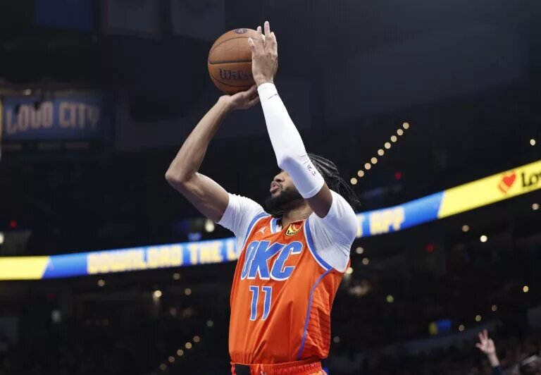 Oklahoma City Thunder guard Isaiah Joe (11) shoots a three point basket against the Dallas Mavericks during the second quarter at Paycom Center.