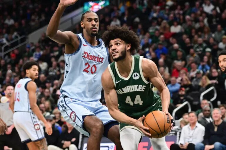 Dec 21, 2024; Milwaukee, Wisconsin, USA; Milwaukee Bucks forward Andre Jackson Jr. (44) drives against Washington Wizards center Alex Sarr (20) in the second quarter at Fiserv Forum.