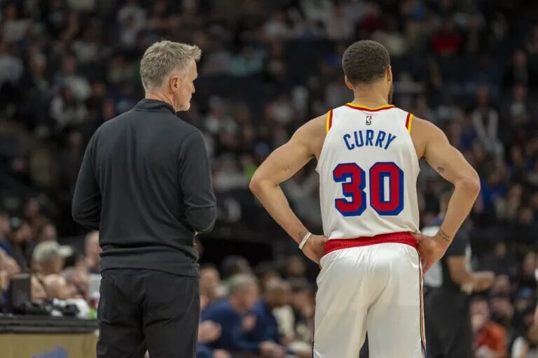 Golden State Warriors head coach Steve Kerr and guard Stephen Curry (30) look on against the Minnesota Timberwolves in the second half at Target Center.