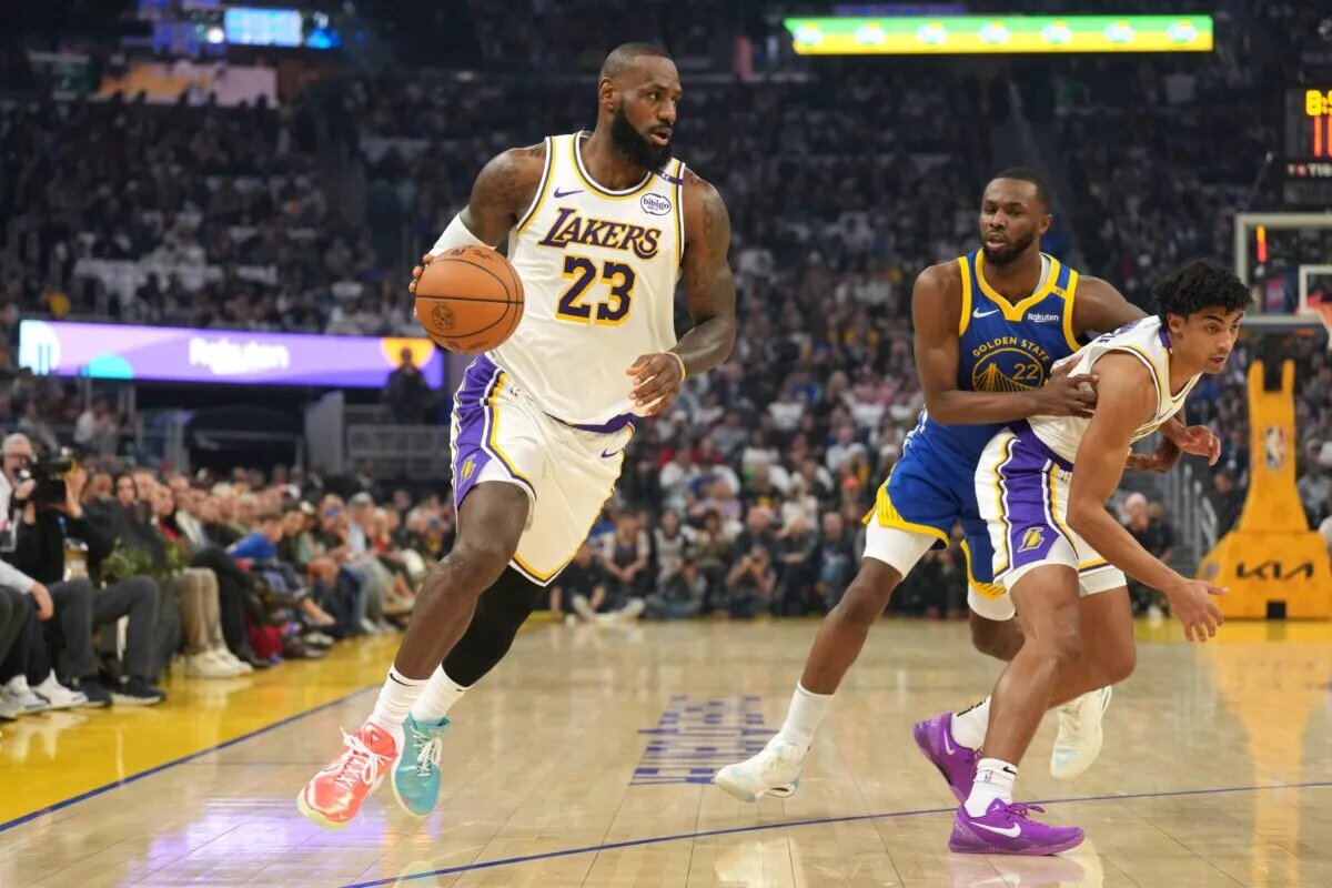 Dec 25, 2024; San Francisco, California, USA; Los Angeles Lakers forward LeBron James (23) dribbles around a screen set by guard Max Christie (right) against Golden State Warriors forward Andrew Wiggins (22) during the first quarter at Chase Center. Mandatory Credit: Darren Yamashita-Imagn Images