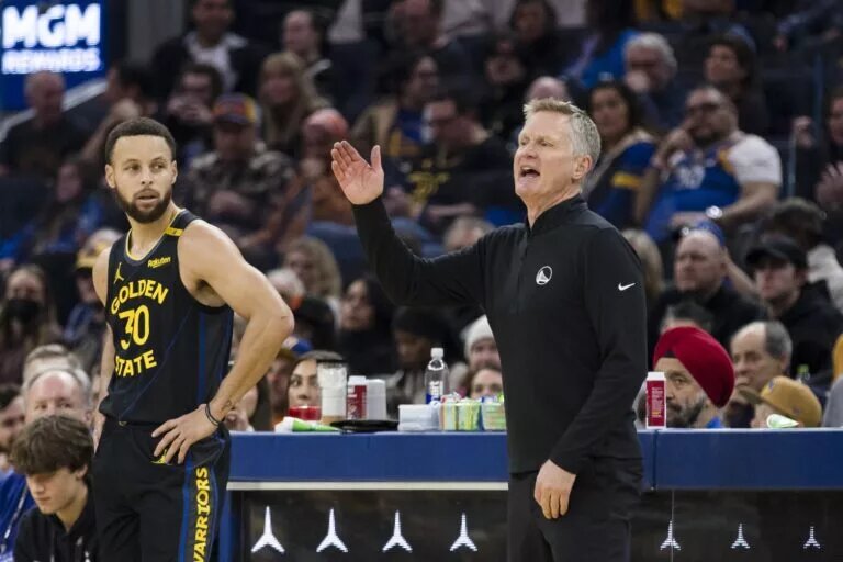Golden State Warriors guard Stephen Curry (30) watches as head coach Steve Kerr reacts during the first quarter of the game against the Cleveland Cavaliers against the Cleveland Cavaliers at Chase Center.