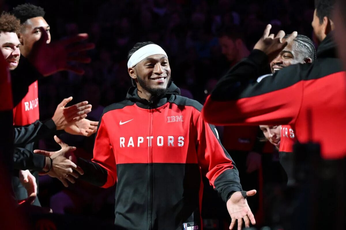 Toronto Raptors guard Immanuel Quickley (5) is greeted by teammates during player introductions before tip off against the Brooklyn Nets at Scotiabank Arena.