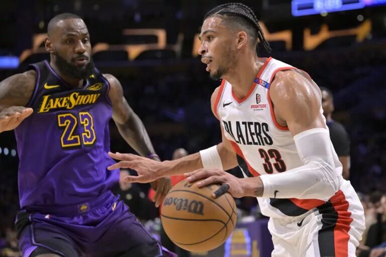 Portland Trail Blazers forward Toumani Camara (33) drives past Los Angeles Lakers forward LeBron James (23) in the first half at Crypto.com Arena.
