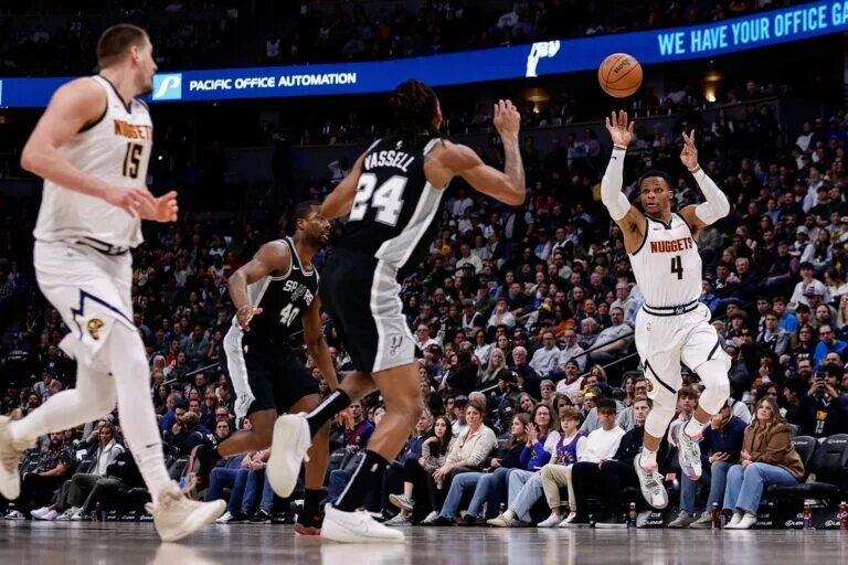 Jan 3, 2025; Denver, Colorado, USA; Denver Nuggets guard Russell Westbrook (4) passes the ball to center Nikola Jokic (15).