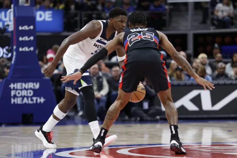 Jan 4, 2025; Detroit, Michigan, USA; Minnesota Timberwolves guard Anthony Edwards (5) dribbles defended by Detroit Pistons guard Marcus Sasser (25) in the second half at Little Caesars Arena.