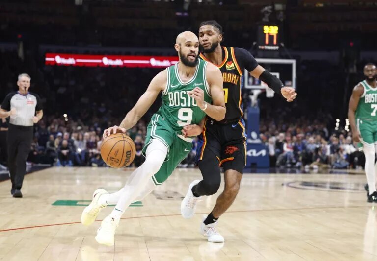 Jan 5, 2025; Oklahoma City, Oklahoma, USA; Boston Celtics guard Derrick White (9) drives around Oklahoma City Thunder guard Isaiah Joe (11) during the second quarter at Paycom Center.