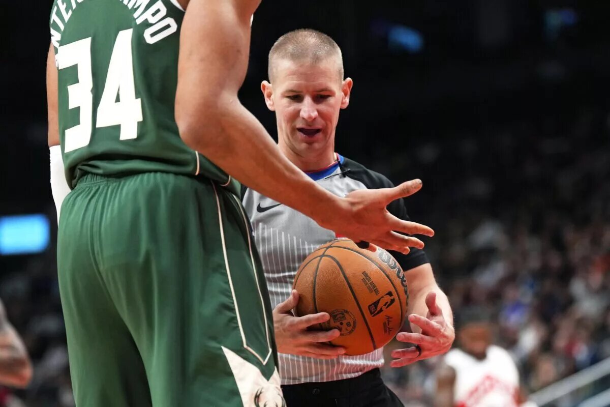 Jan 6, 2025; Toronto, Ontario, CAN; The NBA referee looks at Milwaukee Bucks forward Giannis Antetokounmpo (34) taped up finger against the Toronto Raptors during the third quarter at Scotiabank Arena.
