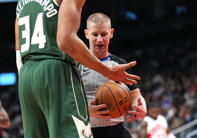 Jan 6, 2025; Toronto, Ontario, CAN; The NBA referee looks at Milwaukee Bucks forward Giannis Antetokounmpo (34) taped up finger against the Toronto Raptors during the third quarter at Scotiabank Arena.