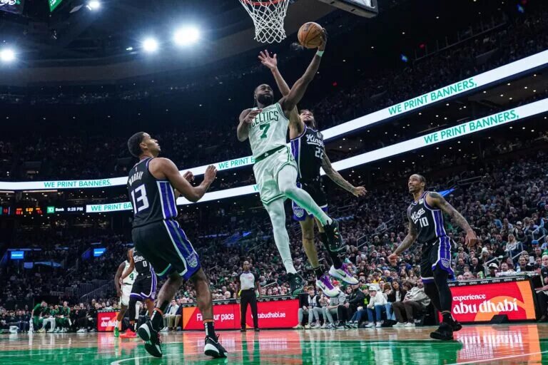Jan 10, 2025; Boston, Massachusetts, USA; Boston Celtics guard Jaylen Brown (7) shoots against Sacramento Kings guard Devin Carter (22) in the second half at TD Garden.
