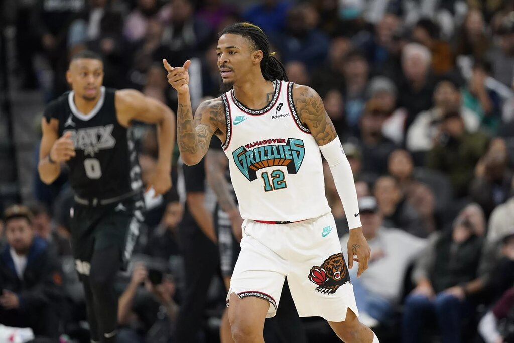 Memphis Grizzlies guard Ja Morant (12) reacts after scoring a three point basket during the second half at Frost Bank Center.