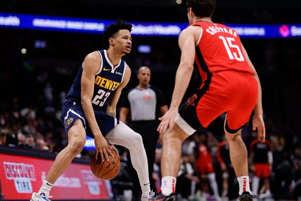 Jan 15, 2025; Denver, Colorado, USA; Denver Nuggets guard Trey Alexander (23) controls the ball against Houston Rockets guard Reed Sheppard (15) in the fourth quarter at Ball Arena.