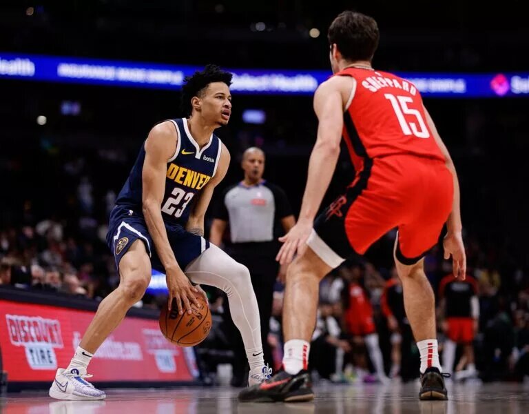 Jan 15, 2025; Denver, Colorado, USA; Denver Nuggets guard Trey Alexander (23) controls the ball against Houston Rockets guard Reed Sheppard (15) in the fourth quarter at Ball Arena.