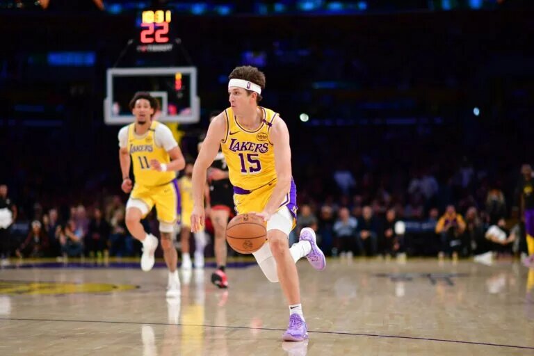 January 15, 2025; Los Angeles, California, USA; Los Angeles Lakers guard Austin Reaves (15) moves the ball against the Miami Heat during the second half at Crypto.com Arena. Mandatory Credit: Gary A. Vasquez-Imagn Images