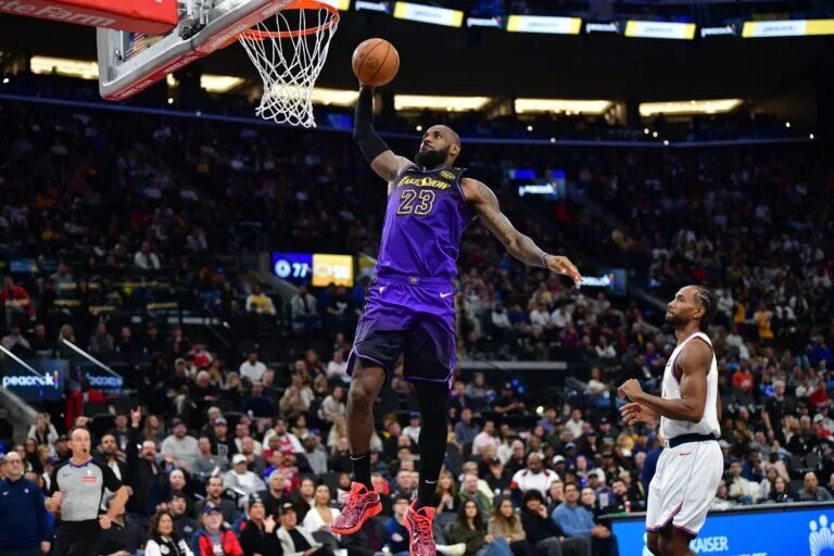 Jan 19, 2025; Inglewood, California, USA; Los Angeles Lakers forward LeBron James (23) dunks for the basket in front of Los Angeles Clippers forward Kawhi Leonard (2) during the second half at Intuit Dome. Mandatory Credit: Gary A. Vasquez-Imagn Images