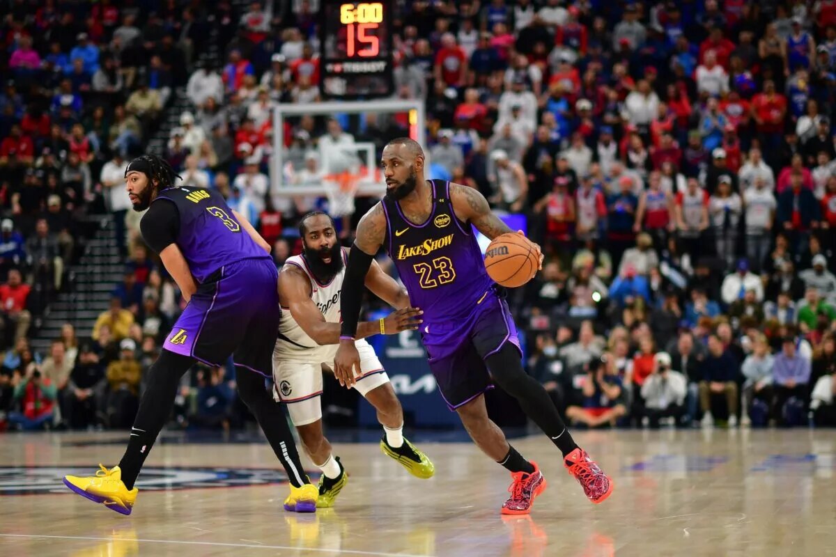 Jan 19, 2025; Inglewood, California, USA; Los Angeles Lakers forward LeBron James (23) moves the ball as forward Anthony Davis (3) provides coverage against Los Angeles Clippers guard James Harden (1) during the second half at Intuit Dome.